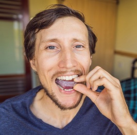 Invisalign patient in Williamstown putting in trays