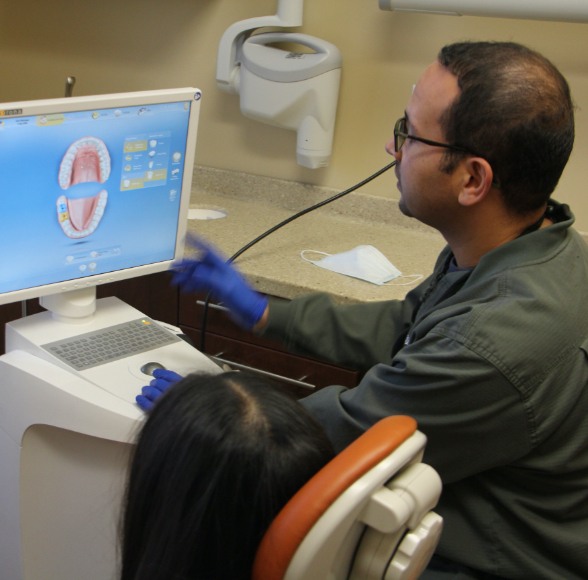 Dentist and patient looking at digital images on chairside computer