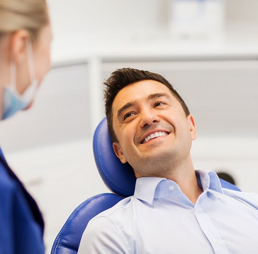 smiling man learning about advanced implant procedures in Williamstown