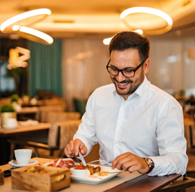 Man smiling while enjoying meal at restuarant
