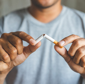 Closeup of patient breaking cigarette