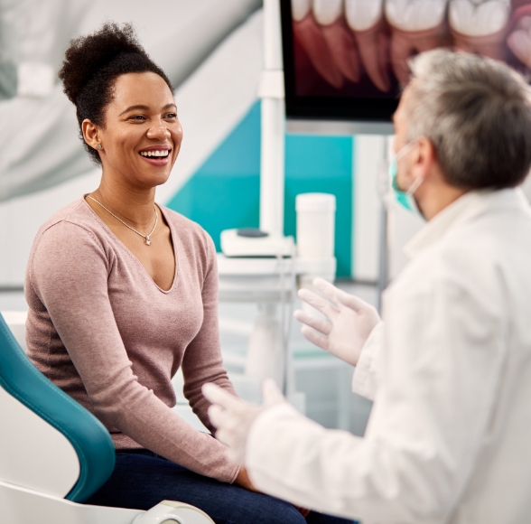 Dentist talking to woman during dental checkups and teeth cleanings