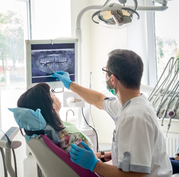 Dentist and patient looking at x-rays during dental checkup