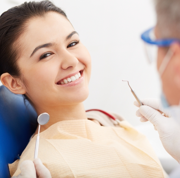 Woman smiling during teeth cleaning visit