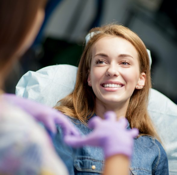 Woman smiling at dentist during dental checkup