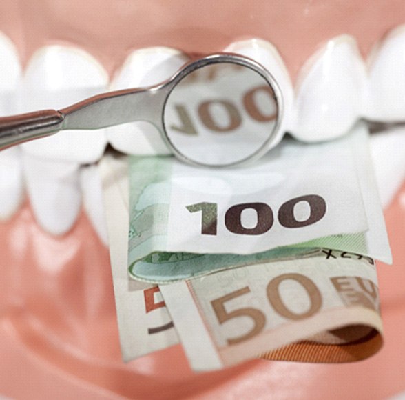 Money being held in a set of teeth