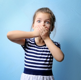 Young girl with knocked out tooth covering her mouth