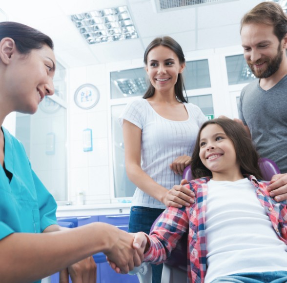 Parents and child at dental office for family dentistry