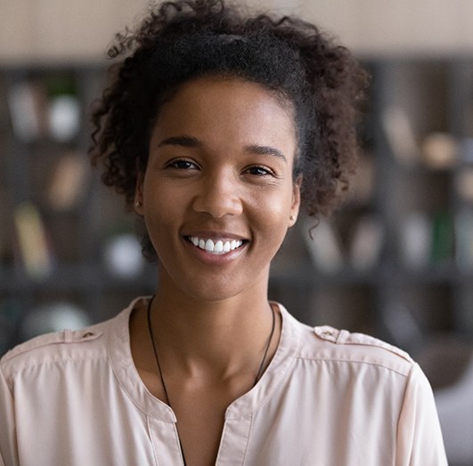 Woman smiling after receiving dental implants in Williamstown, NJ