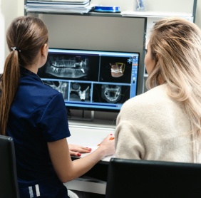 Dental team members reviewing smile x-rays considering preparatory treatments