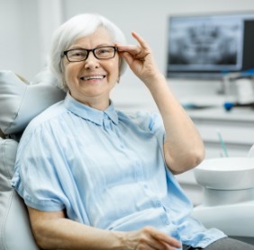 Older woman in dental chair smiling