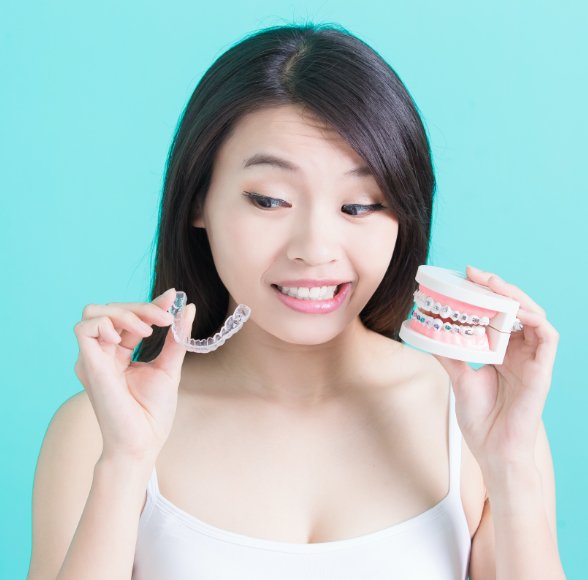 Woman comparing Invisalign and traditional braces