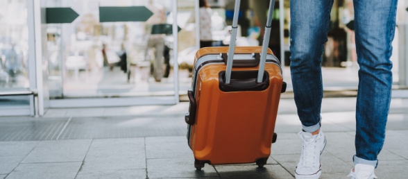 Person pulling a rolling suitcase