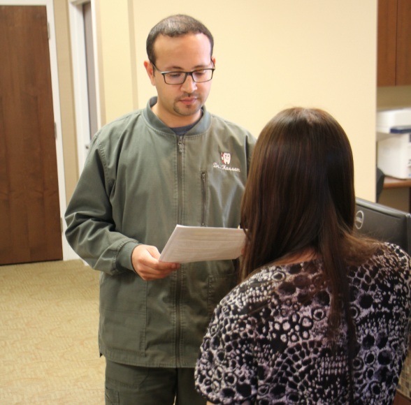 Dentist reviewing patient's dental insurance forms