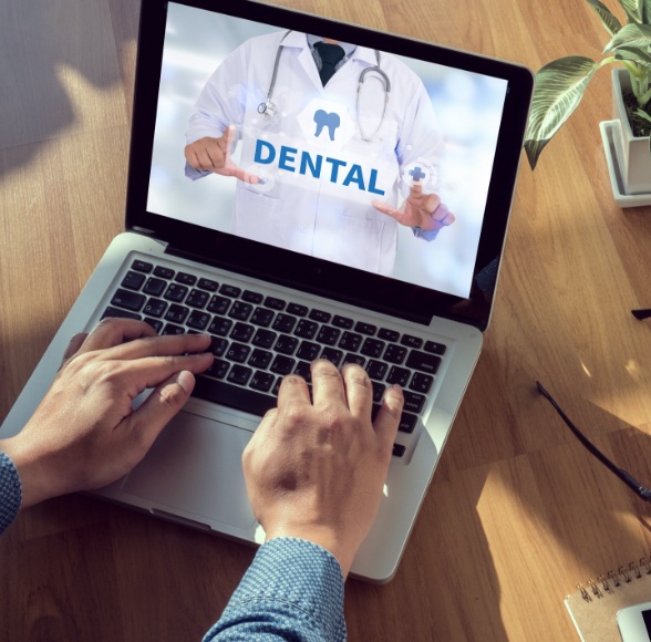 Dental patient reviewing dental insurance on computer screen