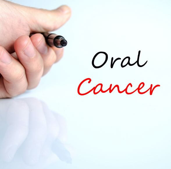 Person writing the words oral cancer