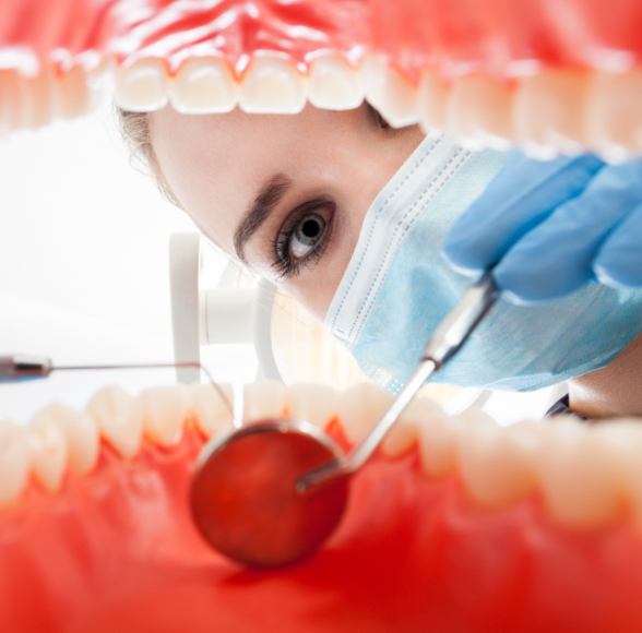 Dentist performing an oral cancer screening