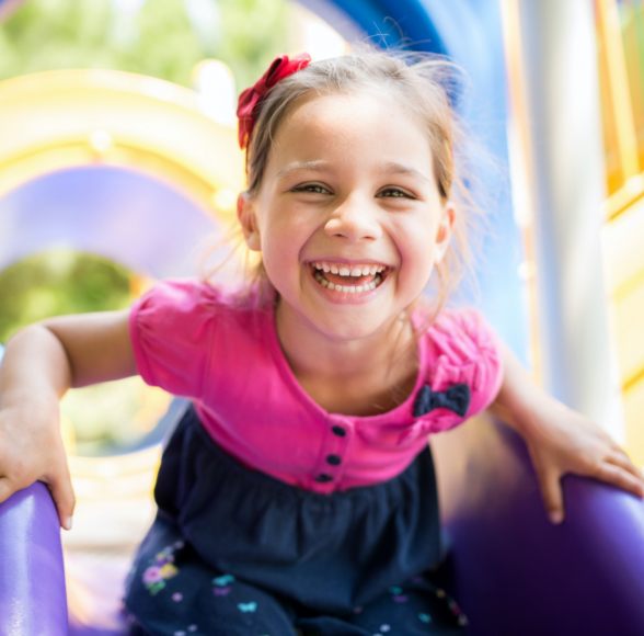 Little girl with dental sealants smiling