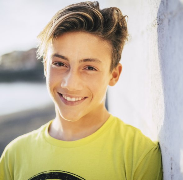 Young man with dental sealants smiling