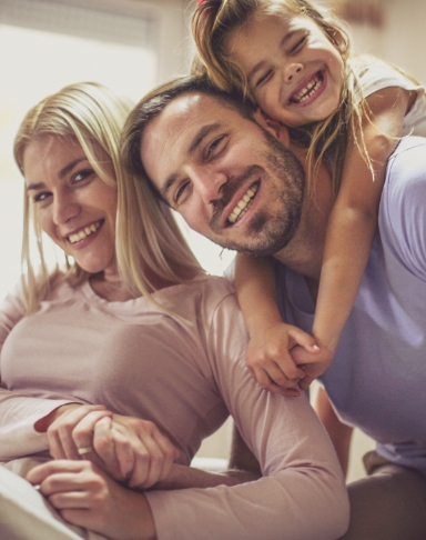 Mother father and child smiling after family dentistry visit