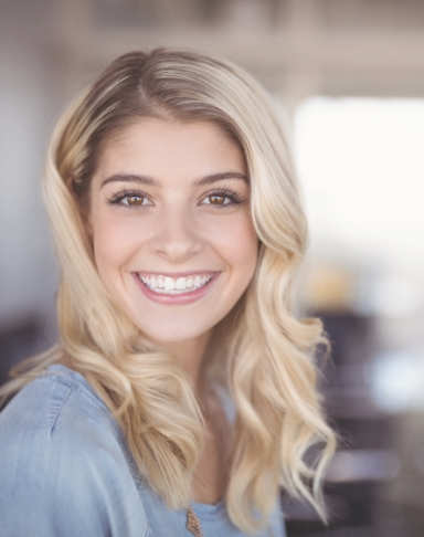 Woman with beautiful smile after Invisalign treatment