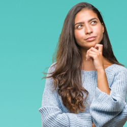 Woman in a thinking pose on blue background
