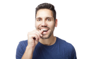 Man placing clear aligner tray