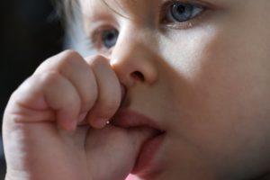 close up of child thumb sucking 