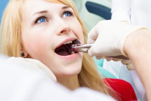 young woman getting her tooth pulled 