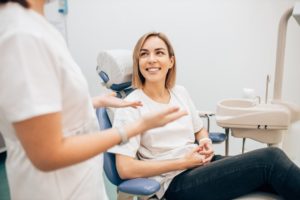 dentist explaining to a patient how autoimmune disorders impact oral health 