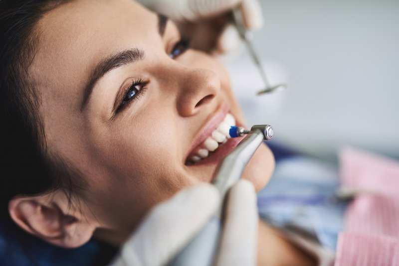 young woman receiving dental cleaning 