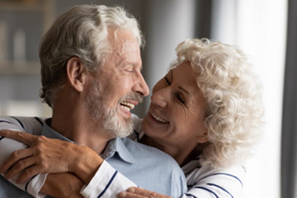 A couple smiling and enjoying their dental implants.