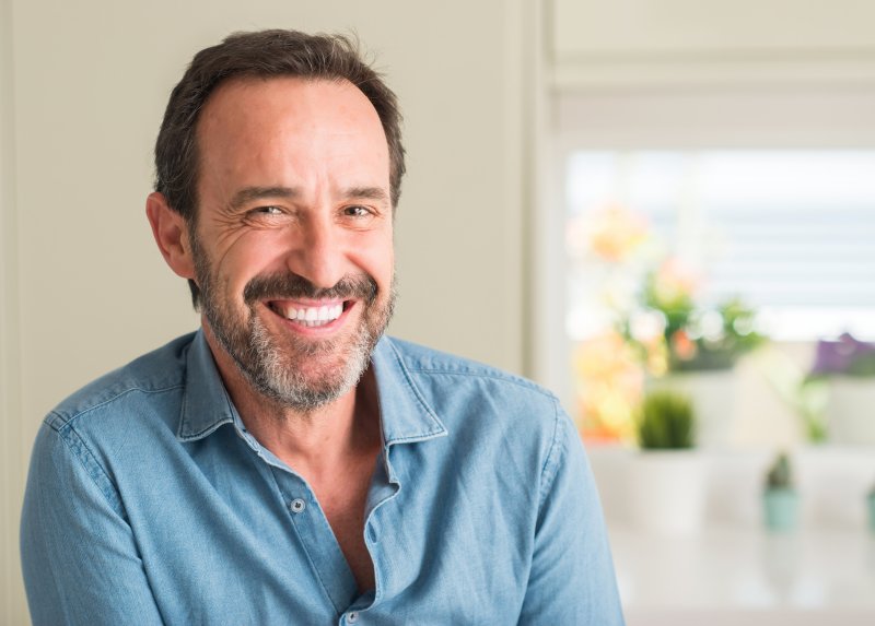 man smiling after a transition from dentures in Williamstown