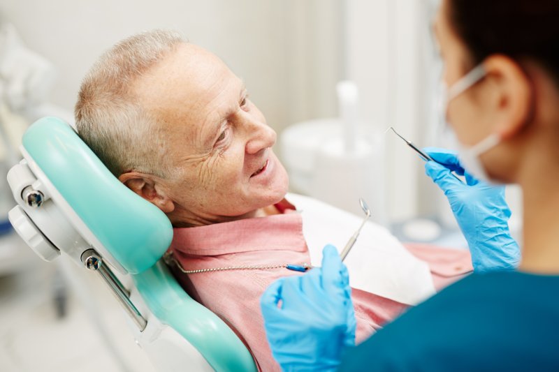 older man in the treatment chair preparing for dental checkup