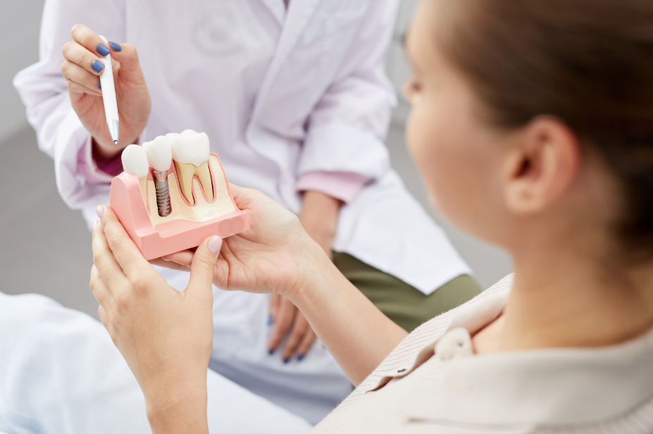 Dentist showing patient dental implant mold